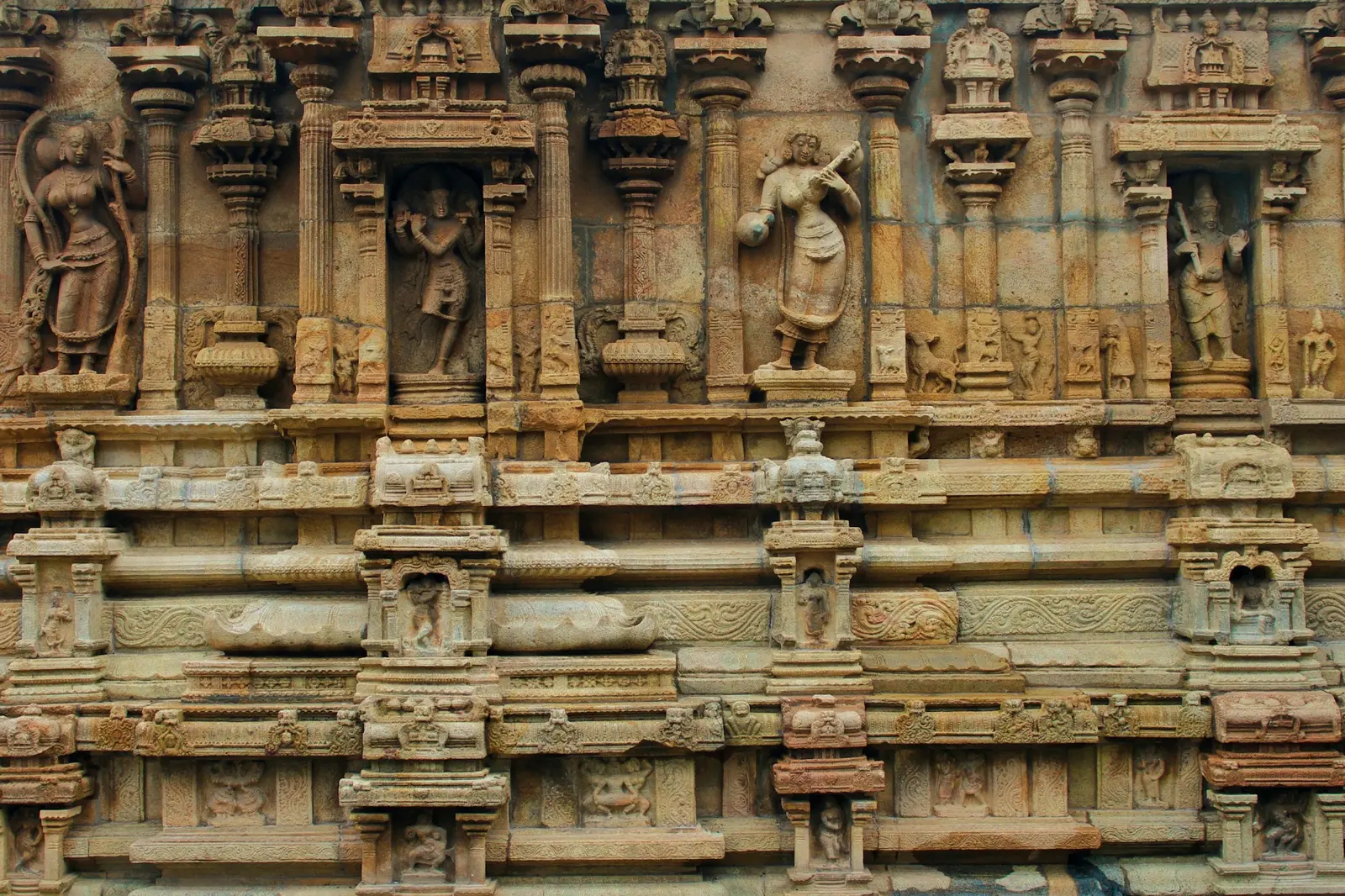 Ancient temple wall with sculpted deities